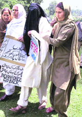 Zamrooda Habib (second from left), chairperson of the Muslim Khawateen Markaz (MKM), and veiled activist of the party being taken in custody after the police thwarted their protest march in Srinagar on Monday.