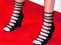 This model flaunts her black caged platform heels with lan at the MTV Movie Awards Photo: Parvesh Chauhan
