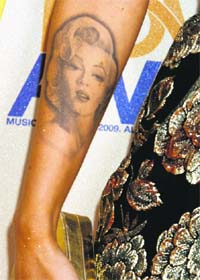 (L) the M-arilyn Monroe tattoo that Megan (R) wears on her arm
