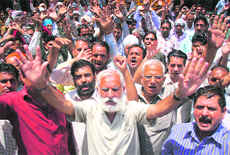 Members of the Water Works Employees Union (PHE) protest in support of their demands in Jammu on Tuesday.