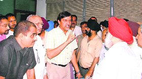 An indignant Harish Rai Dhanda, along with Sat Pal Gosain and Kamal Chatley, seems to be serving a warning to Dr Gurinder Singh Sodhi, executive officer of the Ludhiana Improvement Trust in Ludhiana on Tuesday.