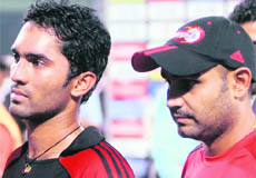 Dinesh Karthik (L) has been named as Virender Sehwags replacement.