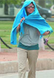 A girl takes shelter with a scarf.