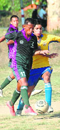 A match of the Ist SN Kharola Memorial Football tournament in progress at Dehradun on Wednesday.