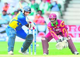Sanath Jayasuriya (L) hits the ball as Denesh Ramdin looks