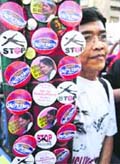 A vendor sells anti-government souvenirs during a protest against a government proposal which protesters call Cha-Cha (Charter Change along a busy street of Makati in Manila on Wednesday.