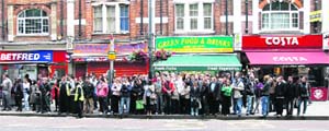 Commuters queue up for buses in Shepherds Bush in west London on Wednesday. They faced two days of transport disruption after a strike inunderground rail network.