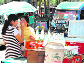 A mother and daughter sip a cold drink bought from a roadside vendor as the mercury soars over 38 degrees in Dehradun on Thursday.