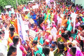 Anganwadi and ASHA workers agitate in front of the Civil Secretariat in Dehradun on Thursday. 