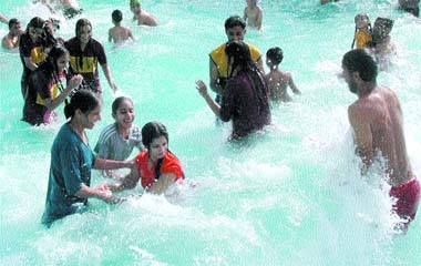 Visitors have fun in the wave pool