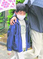 A Japanese boy wears as face mask as he leaves a Japanese International school in the suburb of Duesseldorf in Germany on Thursday.