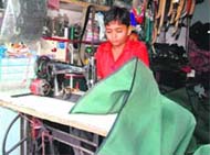 A child sells litchis while another stitches leather pieces for a living. 