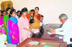 Students of Anand Mayi College with state education minister Madan Kaushik in Haridwar