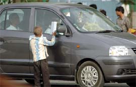 A small child sells tissue papers at a traffic intersection in Gurgaon, where Haryana Chief Minister addressed a seminar to mark World Day Against Child Labour on Friday.
