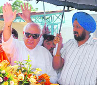 Union Minister for New and Renewable Energy Farooq Abdullah waves to the crowd on arrival in Jammu on Friday.