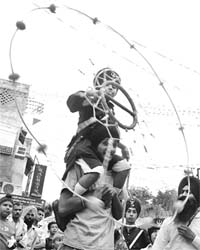 A Sikh boy performs gatka during a nagar kirtan procession being taken out to mark the martyrdom day of Guru Arjan Dev in Patiala