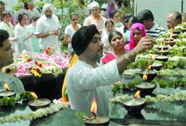 Relatives of the Uphaar victims pay homage to the departed souls near the cinema hall on the occasion of the 12th anniversary of the tragedy in New Delhi