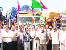 Trucks carrying ration being flagged off at Ahmedgarh on Saturday.