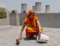 A woman collecting thermal fly ash from the terrace of her house in Bathinda. Tribune photo: Malkiat Singh