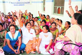 Striking nurses raise slogans in Doon Hospital on Sunday. 