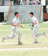 Batsmen cross over for a run in the Krishan Devi Memorial tournament in Dehradun on Sunday.