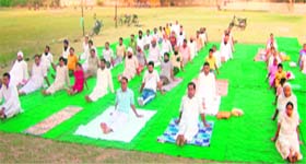 Participants perform yoga during a camp at Amloh on Sunday.
