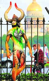 A man poses in body art costume during a tattoo festival in St. Pertersburg, Russia