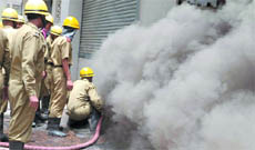 Firemen at work outside the Surya Kirasn Building at Connaught Place in New Delhi on Monday.
