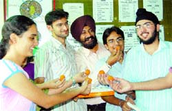 Vipul Bhatia (2nd from right) being congratulated by his fellow students and teachers in Amritsar on Monday.