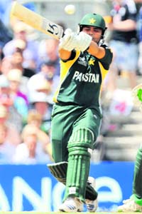 Kamran Akmal (L) plays a shot at the Oval