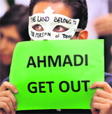 An Iranian demonstrator shows a placard against Iran's President Mahmoud Ahmadinejad during a demonstration outside the UN office in Kuala Lumpur on Monday.
