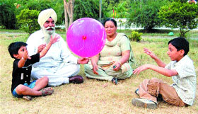 Grand parents play with their grandchildren at Company Bagh in Amritsar.