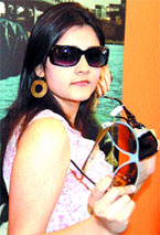 Model showcases different brands of sunglasses in Amritsar.