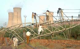 PSEB officials re-erecting the fallen 66 KV tower on the Malout road near Guru Nanak Dev Thermal Power Plant in Bathinda on Tuesday. 