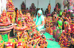 A woman artisan with her creations at Gandhi Shilp Mela at the Parade Ground in Dehradun on Tuesday.
