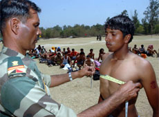 Armymen measure the chest of an applicant during a recruitment rally at Jalandhar Cantonement on Sunday.