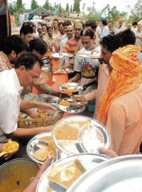 Amarnath pilgrims descend upon the lone community kitchen outside the Yatri Niwas base camp in Jammu