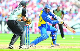 Tillakaratne Dilshan (R) plays a shot against New Zealand at Trent Bridge on Tuesday. 