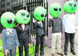 Protesters, dressed as aliens, call for genuine climate change solutions as they try to gain entry into the ongoing dialogue on climate change at Asian Development Bank headquarters in Manila on Tuesday.