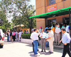 Visitors to the new sub-registrar (west) office forced to stand in the sun in Ludhiana on Wednesday.