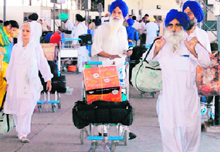 Sikh pilgrims back from Pakistan await clearance at the Attari railway station on Wednesday.
