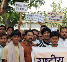 Residents protest against the Municipal Corporation for poor water and power supply in Gurgaon on Thursday.