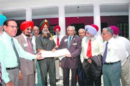 Lieut Gen RS Sujlana being presented Gen AAK Niazis visitors book