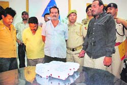 Four narcotics smugglers along with seized heroin in Jammu on Thursday. 