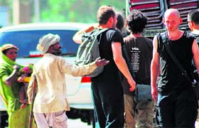 Beggars pester a group of foreign tourists in Chandigarh on Friday.