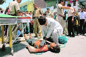 A doctor tries to revive Ashish near the Ashley Hall in Dehradun on Friday.