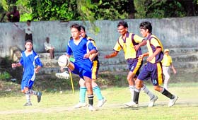 A player dribbles past his opponent during the match in Dehradun on Friday.
