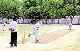 A bowler aims at the stumps during the Krishna Devi Garg Memorial Cricket Tournament at the Survey Ground in Dehradun on Friday.