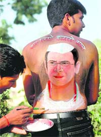 A Congress worker gets a picture of the party general secretary Rahul Gandhi painted on his back on the occasion of latters birthday