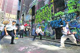 Indian students and Australian cops play cricket in Melbourne on Friday. 